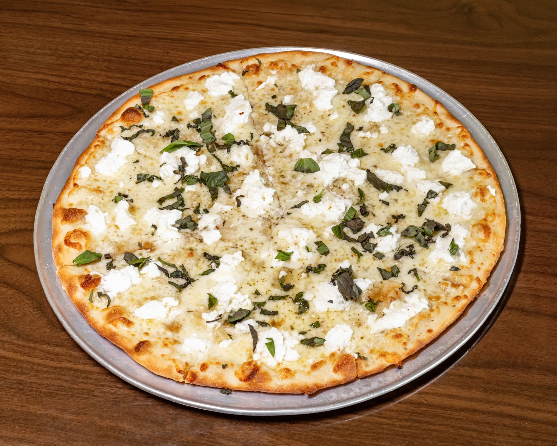 White pizza with ricotta dollops and fresh basil