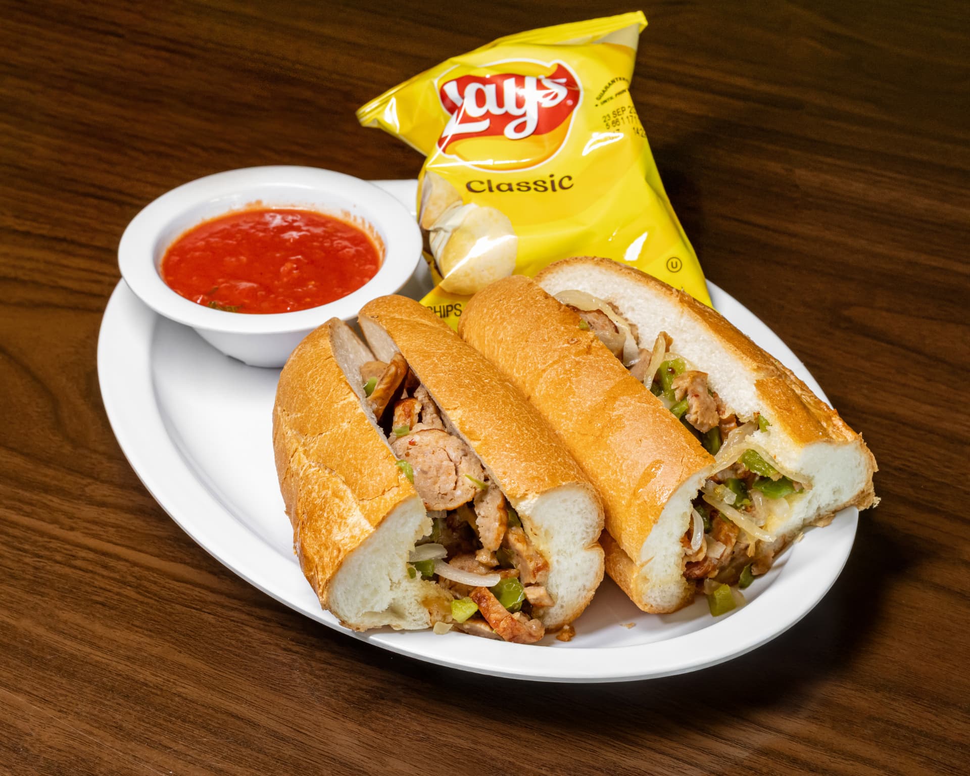 Sausage, peppers and onion sub with chips and marinara